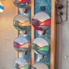 Handcrafted Adirondack stained glass nightlights featuring colorful mountain, lake and pine tree scenes displayed on a wall.